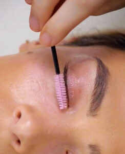 close up of eyelashes being brushed