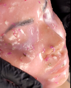 a close up of a woman with a face mask on