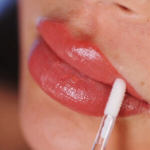 close up of a woman's face during lip blush procedure