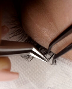 close up of lash extensions being applied in the volume style